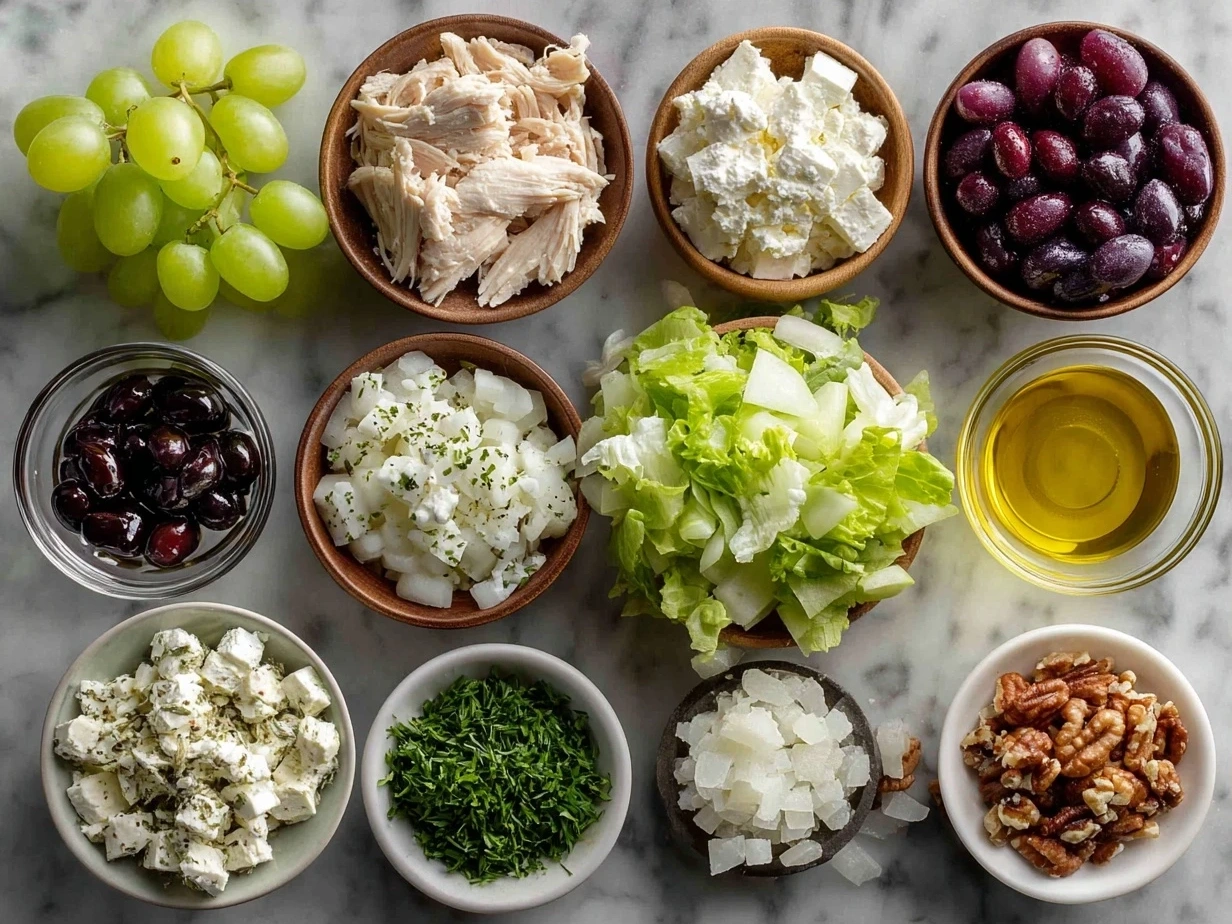 Ingredients for Chicken Salad Chick Grape Salad including grapes, cream cheese, pecans, sugars, and vanilla extract